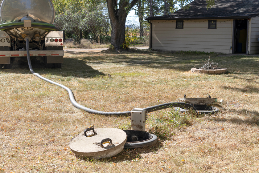 Luna Environmental's septic pump truck servicing a residential septic tank.