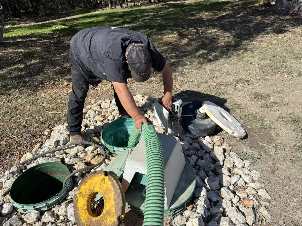 Luna technician at the control panel while pumping out a septic system